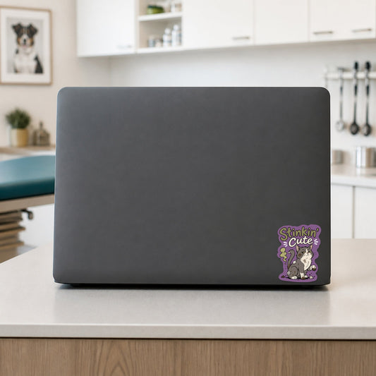 😼 Stinkin’ Cute Cat – Funny Vet Sticker shown on a veterinary clinic laptop