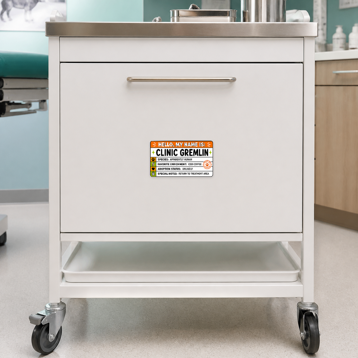 Clinic Gremlin 5.25 by 3 inch veterinary sticker displayed on a veterinary treatment cart