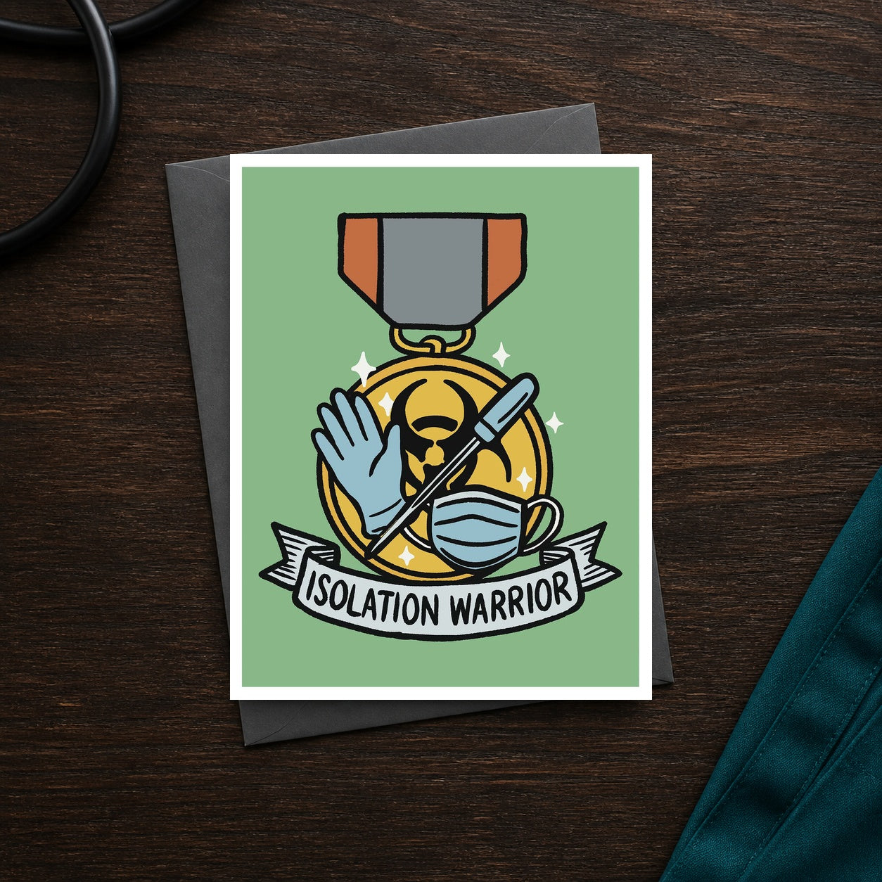Isolation Warrior A2 veterinary recognition notecard front on a dark clinic desk