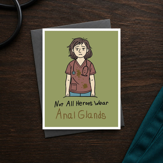 Not All Heroes Wear Anal Glands A2 veterinary notecard front on a dark clinic desk
