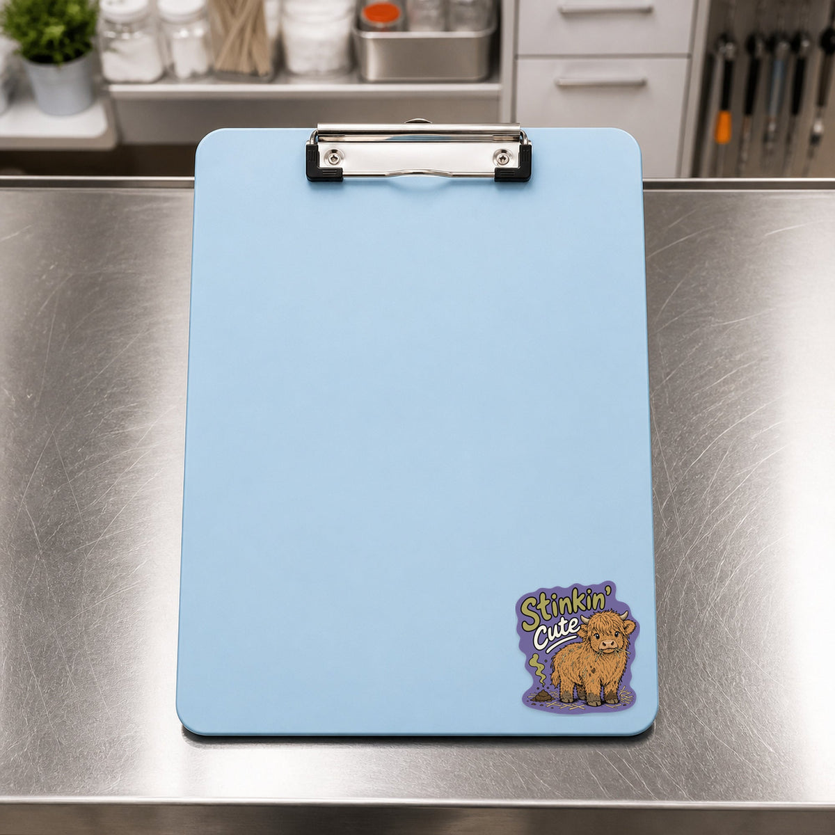 🐮 Stinkin' Cute Highland Cow – Funny Vet Sticker shown on a blue treatment clipboard
