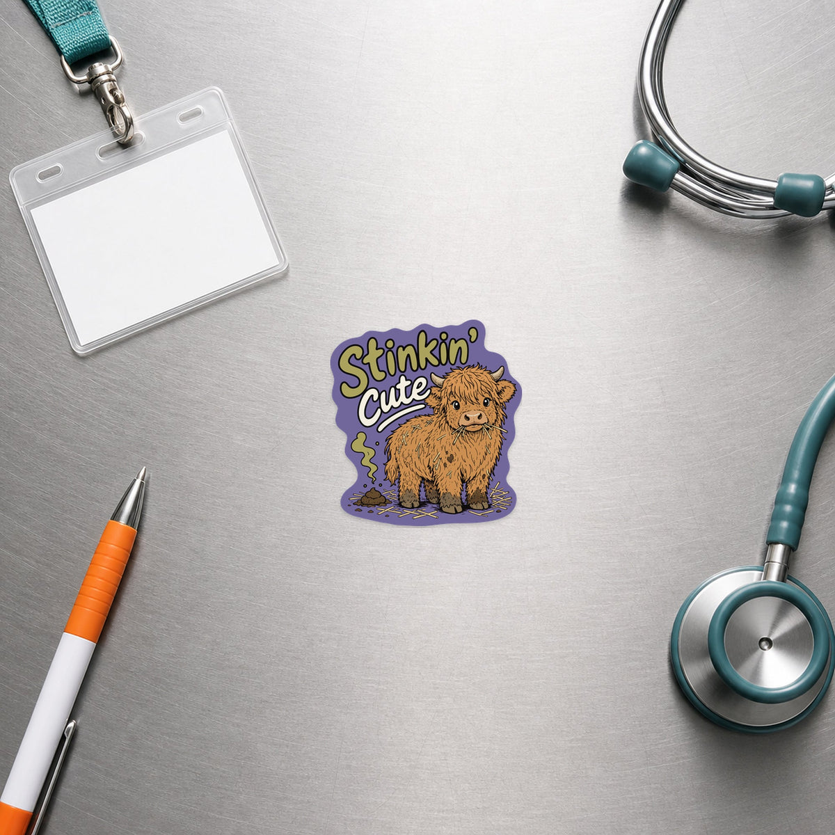 🐮 Stinkin' Cute Highland Cow – Funny Vet Sticker shown in a veterinary clinic flat lay