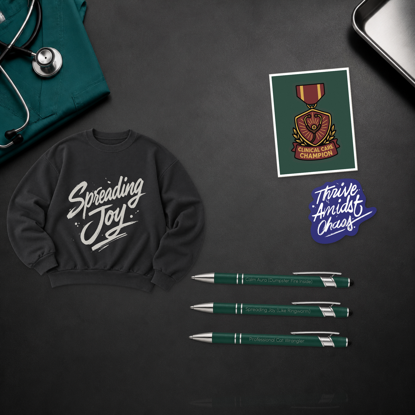 Spreading Joy Uniform Upgrade with a black cropped crewneck, Clinical Care Champion card, three engraved pens, and a Thrive Amidst Chaos sticker, shown in a close material-detail scene for veterinary professionals