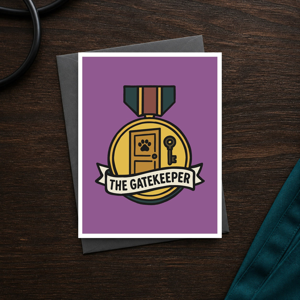 The Gatekeeper A2 veterinary recognition notecard front on a dark clinic desk