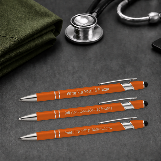 Fall Pen 3-Pack orange veterinary gel pens beside a stethoscope and folded scrubs