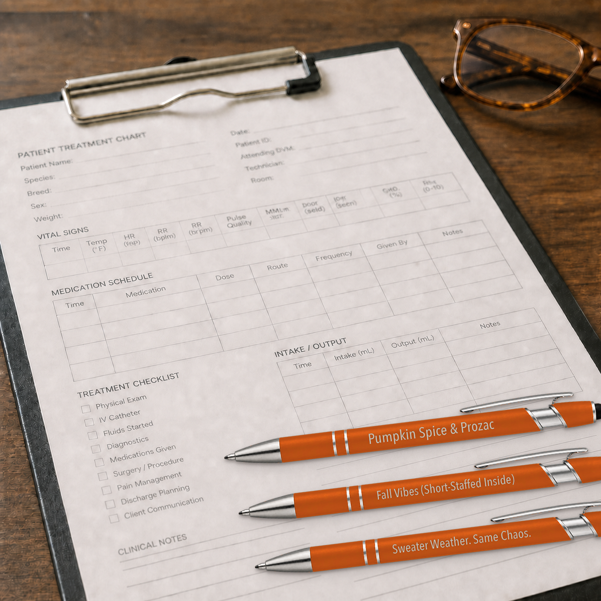 Fall Pen 3-Pack orange veterinary gel pens resting on a clinic treatment chart clipboard