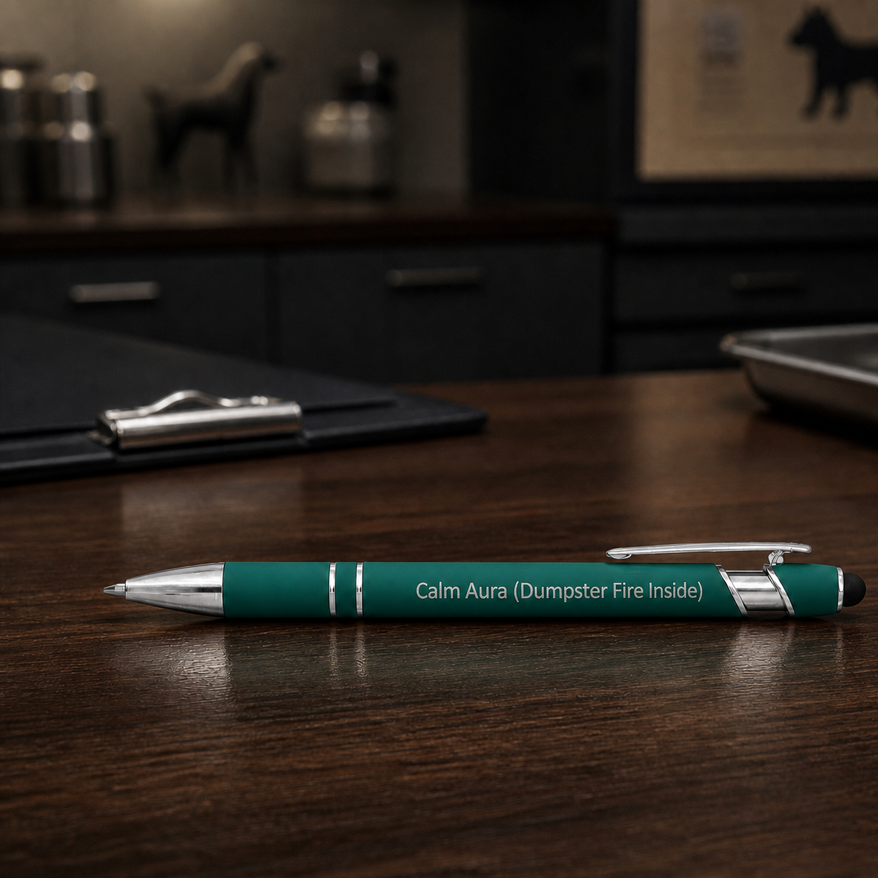 Dark green Calm Aura Dumpster Fire Inside laser-engraved veterinary pen on a dark clinic desk