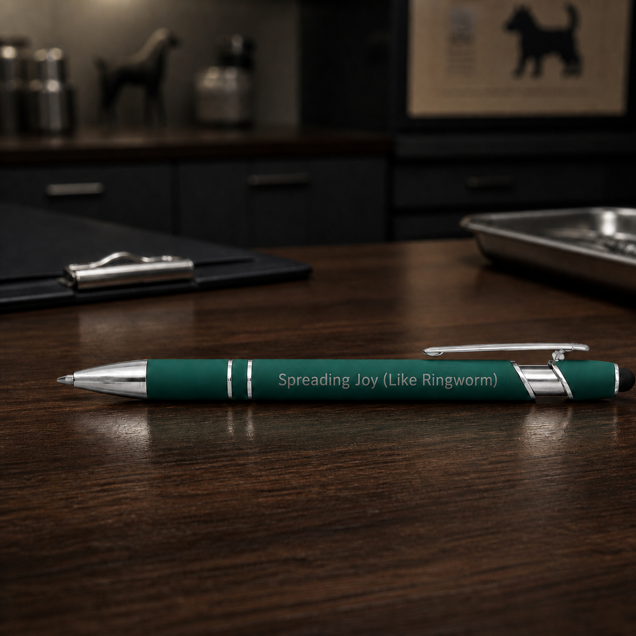 Dark green Spreading Joy Like Ringworm laser-engraved veterinary pen on a dark clinic desk