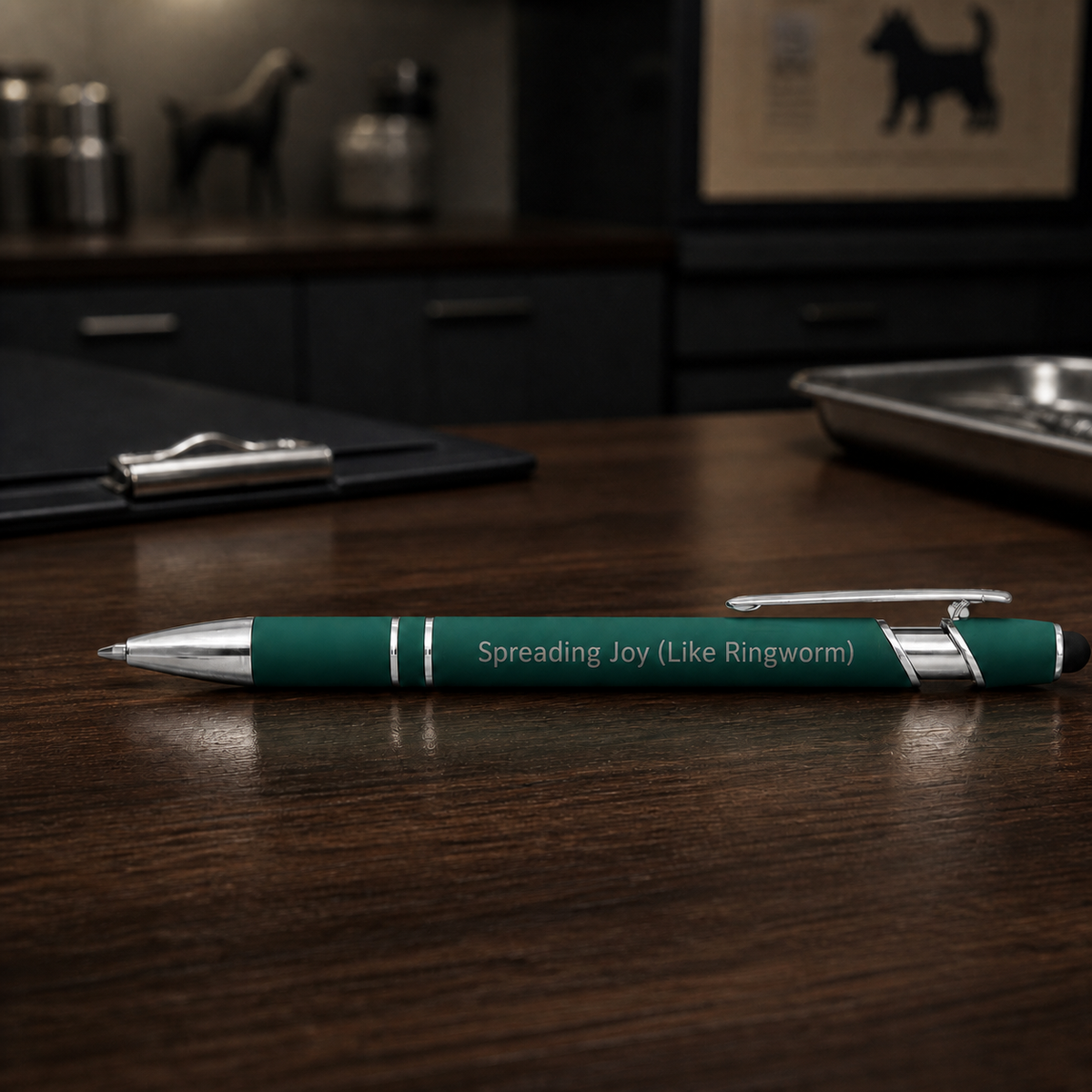 Dark green Spreading Joy Like Ringworm laser-engraved veterinary pen on a dark clinic desk