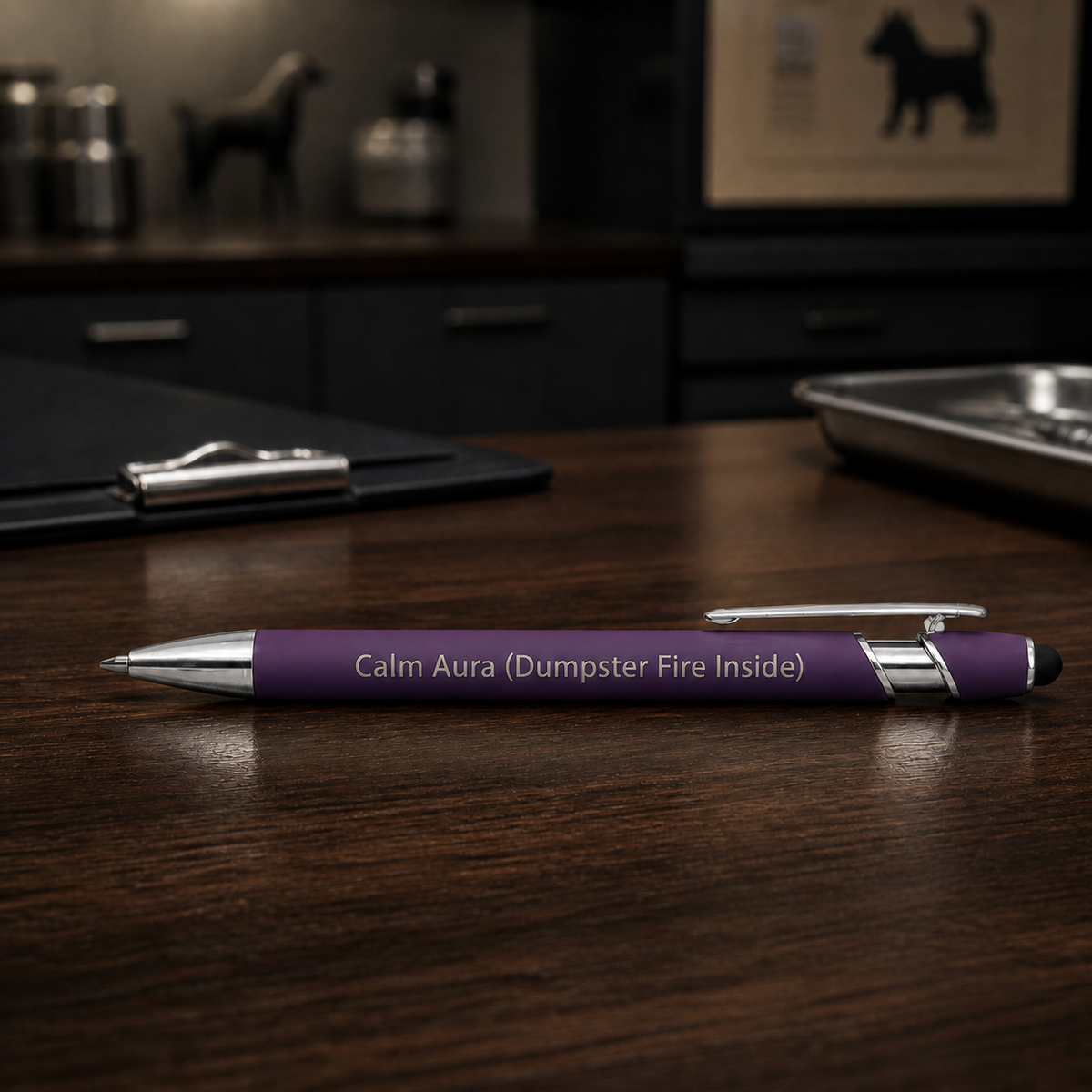 Purple Calm Aura Dumpster Fire Inside laser-engraved veterinary pen with stainless steel hardware on a dark clinic desk