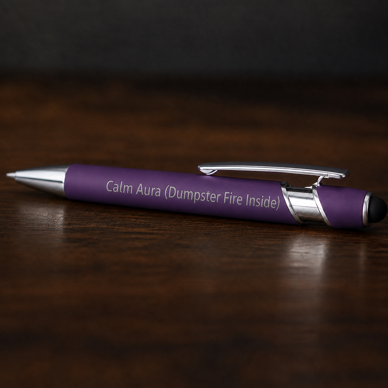 Close view of a purple Calm Aura Dumpster Fire Inside pen with silver engraving and stainless steel hardware