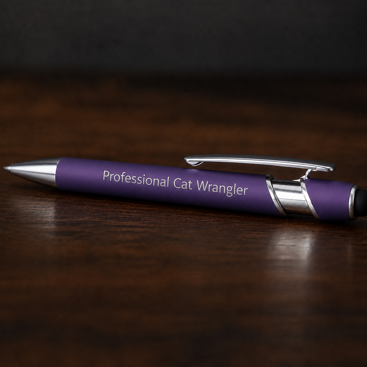 Close view of a purple Professional Cat Wrangler pen with silver engraving and stainless steel hardware