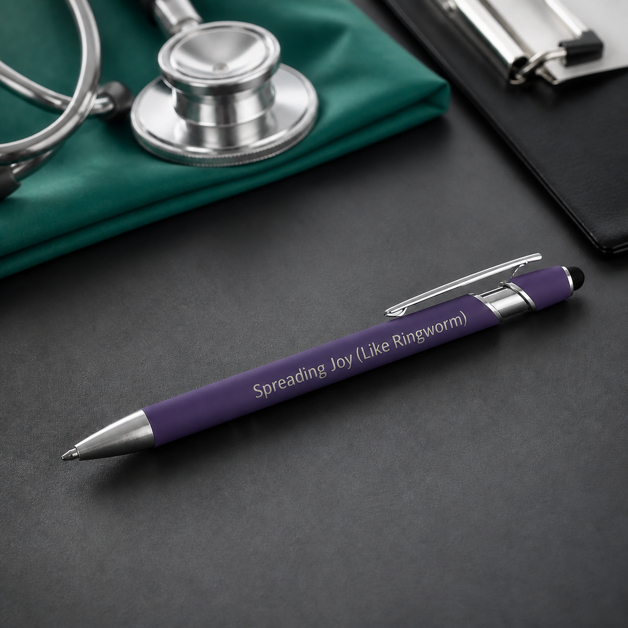 Purple Spreading Joy Like Ringworm laser-engraved veterinary pen with stainless steel hardware on a charcoal desktop