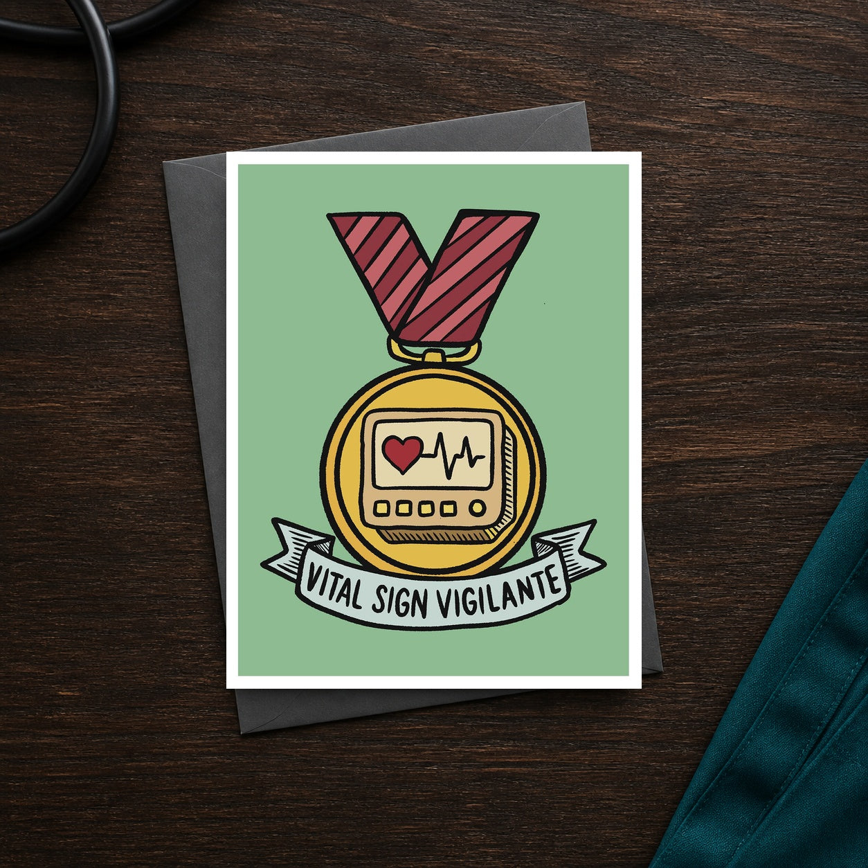 Vital Sign Vigilante A2 veterinary recognition notecard front on a dark clinic desk